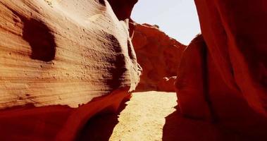  Beautiful traveling shot inside a geological formation showing orange walls and sun flare in 4K video
