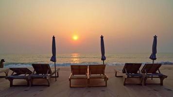 Beach Chair on Sand With Ocean Background and Twilight Sky video