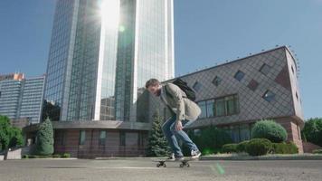 jovem empresário barbudo do sexo masculino andar de skate ao ar livre video