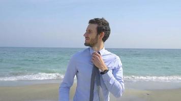giovane uomo d'affari felice sulla spiaggia, concetto di vacanza video