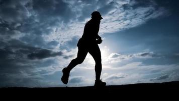 Silhouette Man running in the evening photo