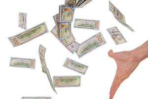 Business concept. Hand with flying money isolated on white background. photo
