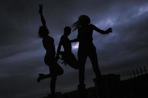 group of people jumping in air in night photo