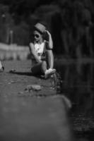 beautiful girl sitting on the pier photo