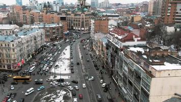Aerial view of snowy Kyiv or Kiev city, top view of streets and cars video