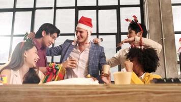 Slow-motion dancing, The group of multiracial workers, boss, and colleagues team celebrates Christmas holiday festival and new year party at the business office workspace, happiness smile, and laugh. video