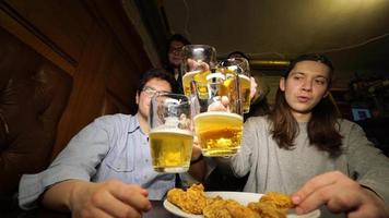 Happy hour at bar, boys drink beer and eat appetizers video