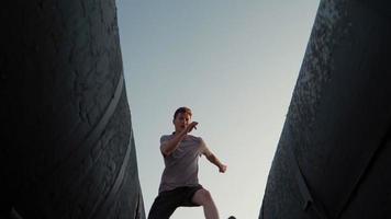 Playful Happy man runs and jumps in the sunlight. Freedom and happiness. Bottom view. Slow motion video