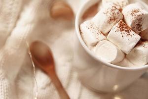Hot chocolate with marshmallow and christmas decorations. Winter cozy home photo