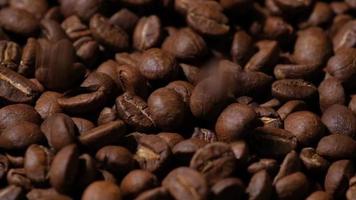 Slow motion of roasted coffee beans falling. Organic coffee seeds. video