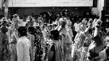 Delhi, India April 03 2022 - Women with Kalash on head during Jagannath Temple Mangal Kalash Yatra, Indian Hindu devotees carry earthen pots containing sacred water with coconut on top-Black and White video