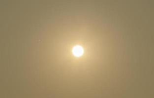 The sun on the yellow sky photo