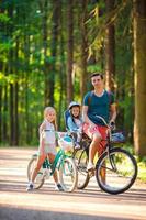 Happy family biking outdoors at the park photo