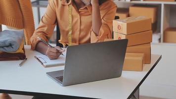 Portrait young attractive hipster asian female owner startup call phone with box at home prepare parcel delivery in sme supply chain, procurement, Asian omnichannel Sme e commerce online concept. video