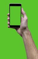 masculino mano participación negro Teléfono móvil con verde croma pantalla a aislado verde antecedentes. foto