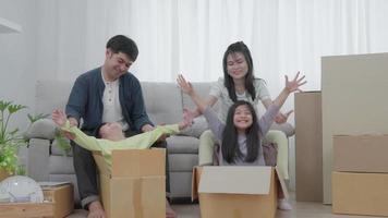 New home for family. activities together during the holidays. Parents and children are having activity on vacant time. weekend, enjoyment, happy family, togetherness, feel good. Move home video