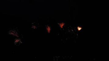 Shining fireworks with bokeh lights in night sky. Glowing fireworks show. New year eve fireworks celebration. Fireworks in night sky. Beautiful colored night explosions in black sky video