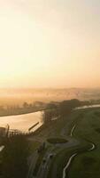 Aerial view of hazy morning light over green rural landscape video