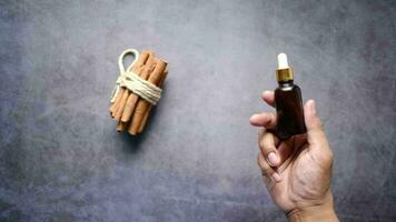 Holding cinnamon essential oil container top view video