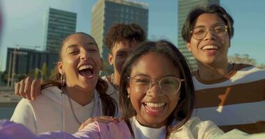 Multiethnic group of young happy friends taking a selfie, view from the camera in slow motion. video