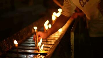 Asian people lighting candles to paying homage Buddha in temple to make a wish on the traditional Songkran festival in Thailand. video