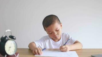 boy sitting and doing homework, drawing, coloring video
