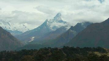 Ama Dablam Mountain and Coniferous Forest. Himalaya, Nepal. Aerial View. Drone Flies Backwards video