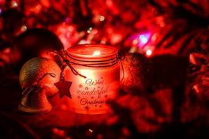 Decorative Christmas background with hanging bauble and candle photo