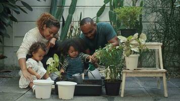 Happy African American family enjoying gardening at home video