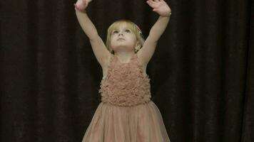 Happy three years old girl make faces and dancing. Cute blonde child video