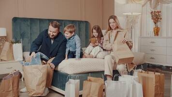 After shopping, dad gives his son a plush shark toy as a gift. Mom and sister are happy for their son and brother. Happy family. The story of one big family. video