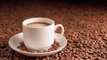 black coffee in small white mug on plate with spinning bubbles on surface covered with coffee beans video