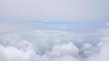 blue sky with white fluffy clouds from airplane flight fly over the clouds in a sunny day with cloud moving in the atmosphere in hot weather summer time. video