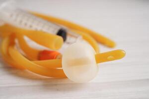 Foley catheter and urine drainage bag collect urine for disability or patient in hospital. photo
