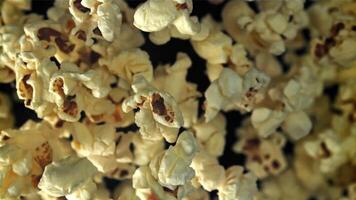 pop corn mouches en haut et chutes bas. sur une noir Contexte. filmé sur une haute vitesse caméra à 1000 ips. haute qualité Full HD métrage video