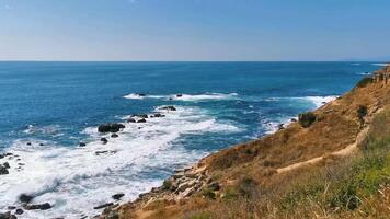 Beautiful rocks cliffs view waves at beach coast panorama Mexico. video