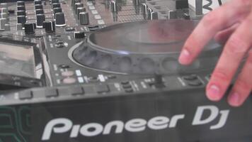 Hands of DJ on mixing console. Slow motion video