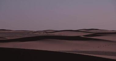 A sand dune of sahara desert at Mhamid el Ghizlane in Morocco telephoto shot video