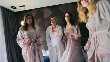 das Braut und ihr freunde sind Tanzen auf das Bett im das Hotel Zimmer auf das Hochzeit Tag. glücklich Hochzeit Tag und Morgen von das Braut mit ihr freunde video