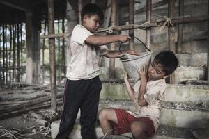 Poor children work in construction sites because of poverty, Child labor, human trafficking, World Day Against Child Labour concept. photo