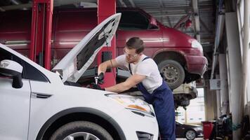 Automobile mechanic repairman hands repairing a car engine automotive workshop with a spanner. Car service and maintenance. Repair service video
