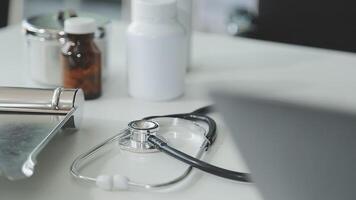 Doctor and nurse examining patient's medical records and medical team working on the background video