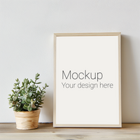 Mockup of frame with black borders on the table with plant psd