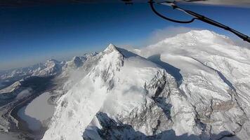 The plane flies over the Himalayan mountains. The tops of the mountains are covered with snow. The area of the eight-thousandth Shishabangma. Tibet. video