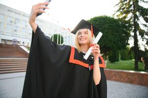 Young female student graduating from university take selfie photo