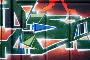 Colorful background of graffiti painting artwork with bright aerosol outlines on wall. Old school street art piece made with aerosol spray paint cans. Contemporary youth culture photo