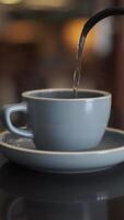 Pouring hot water into a cup on the table video