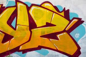 Colorful background of graffiti painting artwork with bright aerosol outlines on wall. Old school street art piece made with aerosol spray paint cans. Contemporary youth culture photo