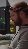 Vertical . Professional esport man gamer looking at camera smiling while compete in videogame playing space shooter game. Online streaming cyber performing on powerful personal computer during gaming tournament video