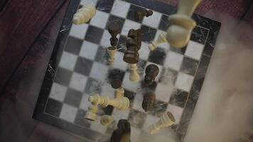 Fallen chess pieces covered in mist for a dramatic effect video